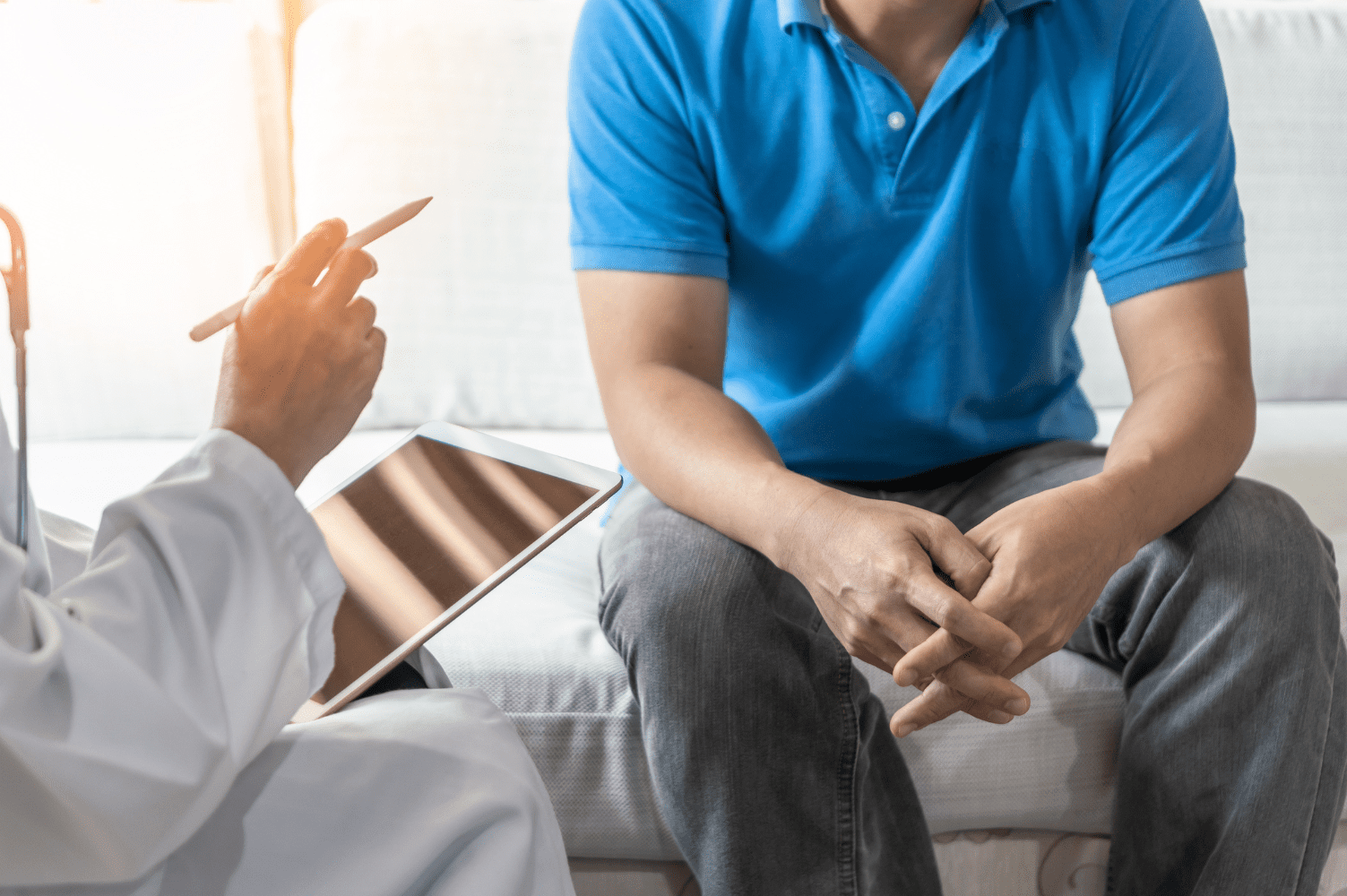 Man consulting a doctor about fertility and sperm health post-vasectomy reversal.